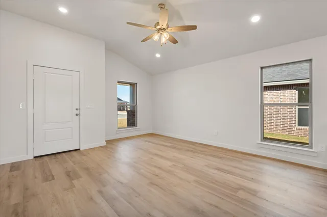 a kitchen with stainless steel appliances granite countertop a sink and a stove top oven with white cabinets