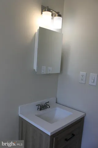 a bathroom with a sink and mirror