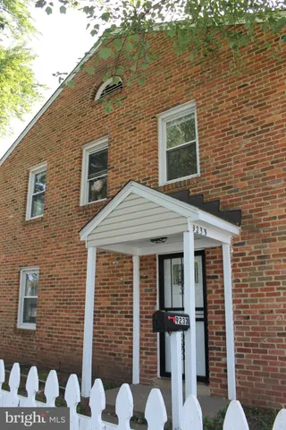a front view of a house with plants
