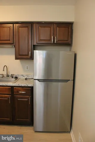 a kitchen with a refrigerator and a sink