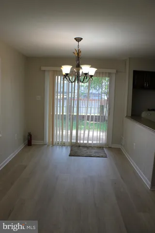en empty room with stairs and wooden floor
