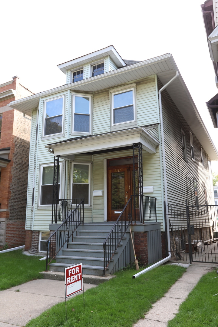 2133 West Grace Street, Unit 2 Chicago, IL 60618 - Photo 1 of 22 a front view of a house with a yard