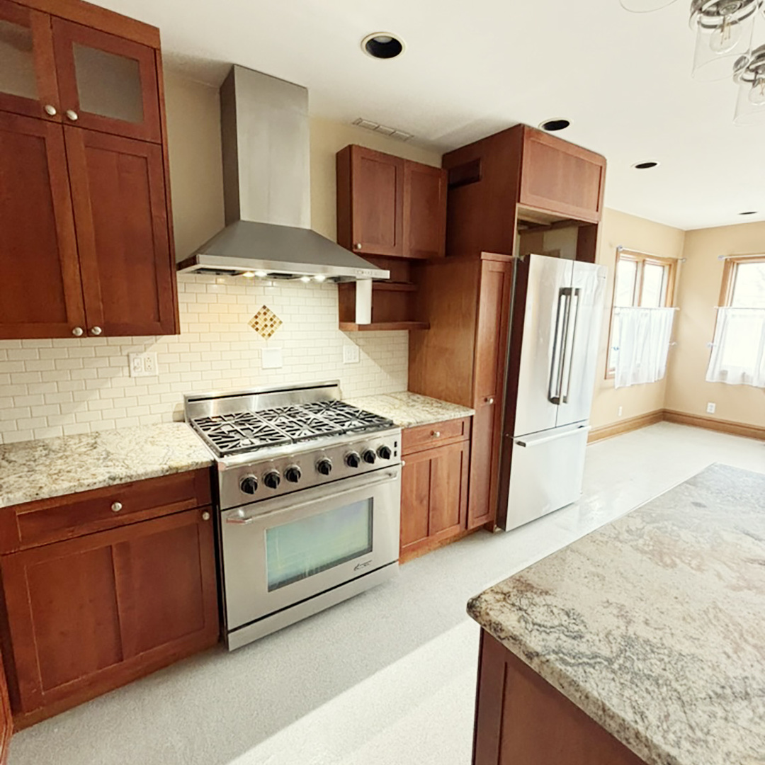 2133 West Grace Street, Unit 2 Chicago, IL 60618 - Photo 2 of 22 a kitchen with stainless steel appliances granite countertop a stove a sink and a refrigerator