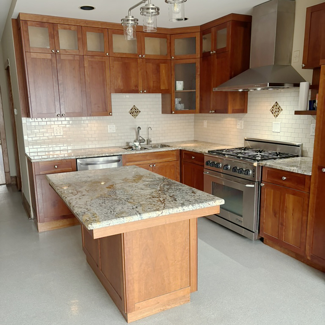 2133 West Grace Street, Unit 2 Chicago, IL 60618 - Photo 3 of 22 a kitchen with granite countertop a sink a stove and a wooden cabinets