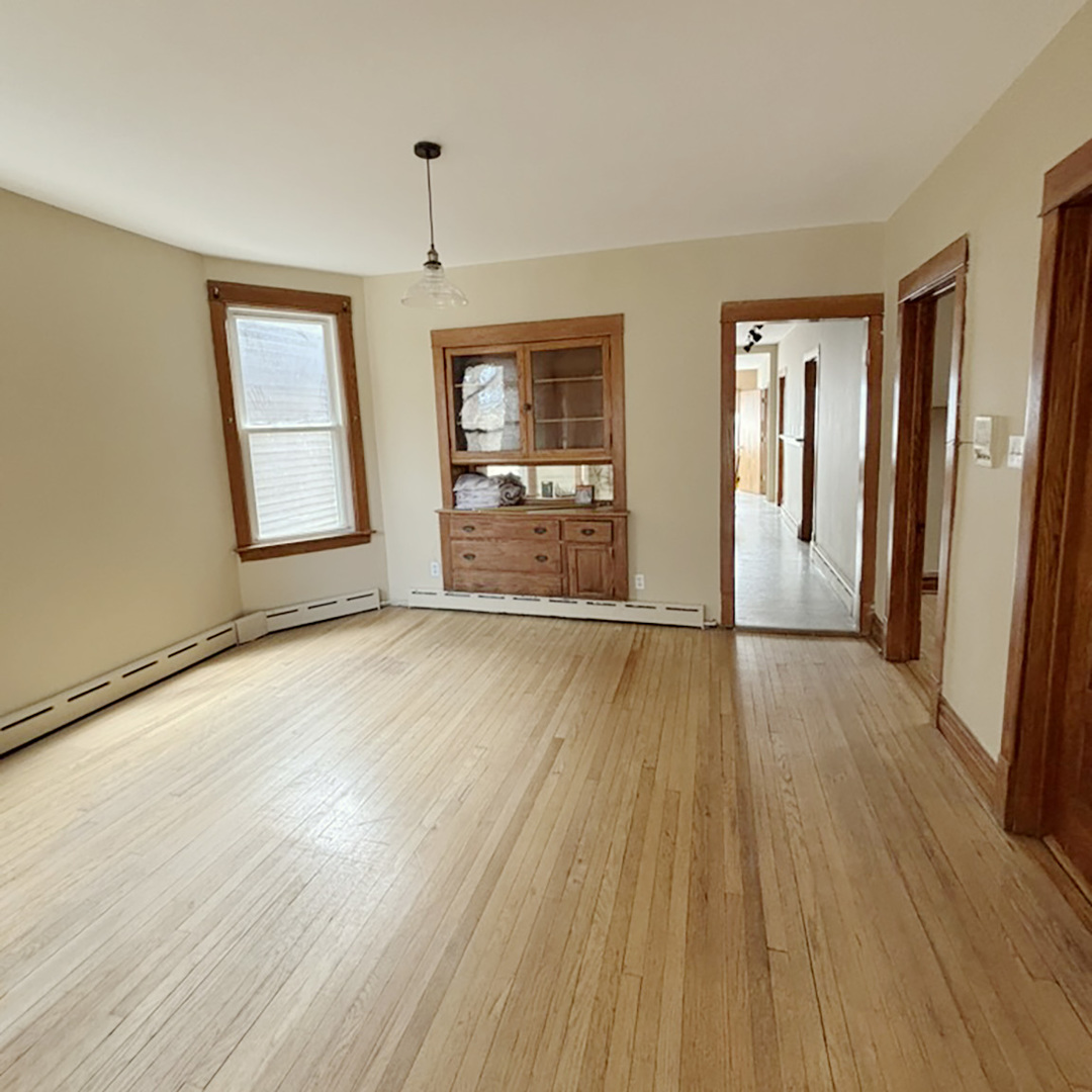 2133 West Grace Street, Unit 2 Chicago, IL 60618 - Photo 7 of 22 an empty room with wooden floor and windows