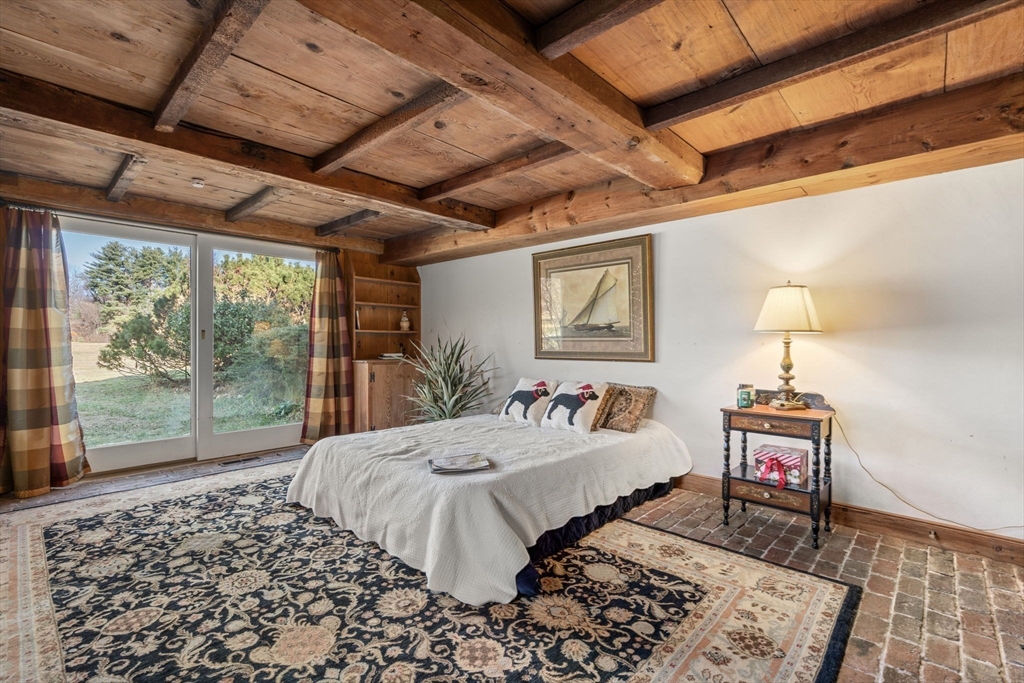 5 Herrick Road Boxford, MA 01921 - Photo 26 of 37 a bedroom with a bed and wooden floor
