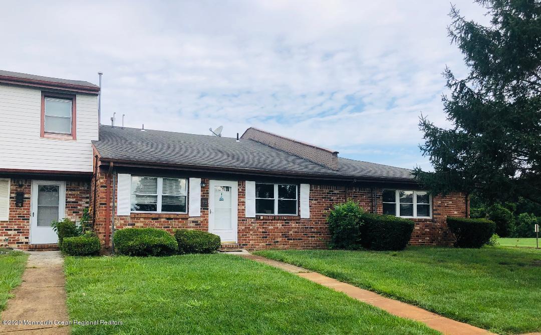 72 Greenwood Loop Road Brick, NJ 08724 - Photo 3 of 15 a front view of a house with a garden and plants