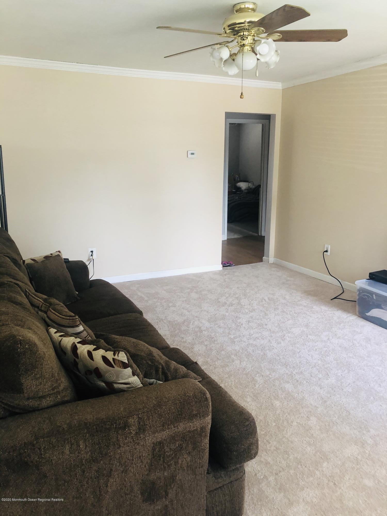 72 Greenwood Loop Road Brick, NJ 08724 - Photo 5 of 15 a living room with furniture and a chandelier