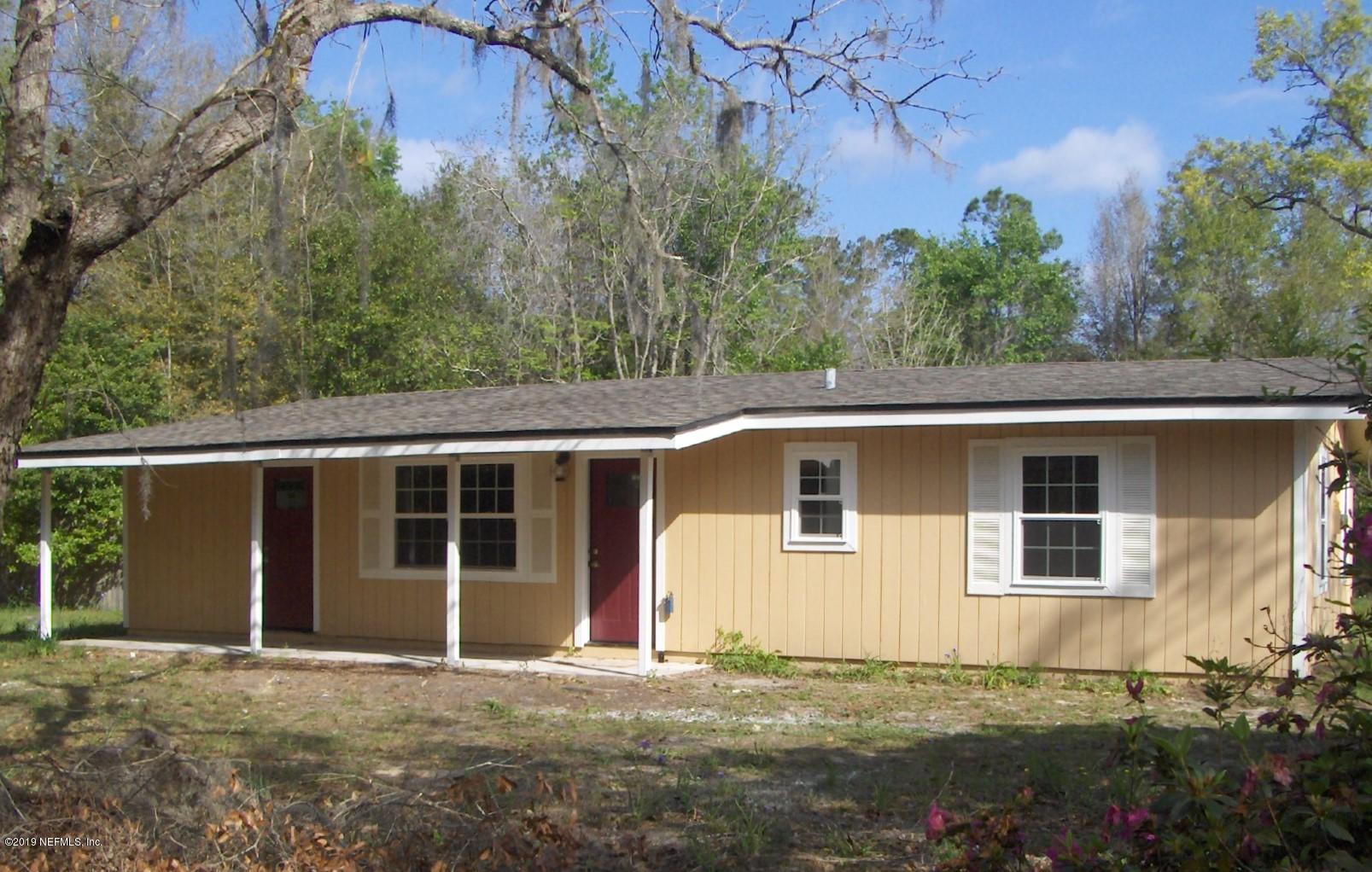 4122 Appaloosa Road Middleburg, FL 32068 - Photo 1 of 18 a front view of a house with a garden