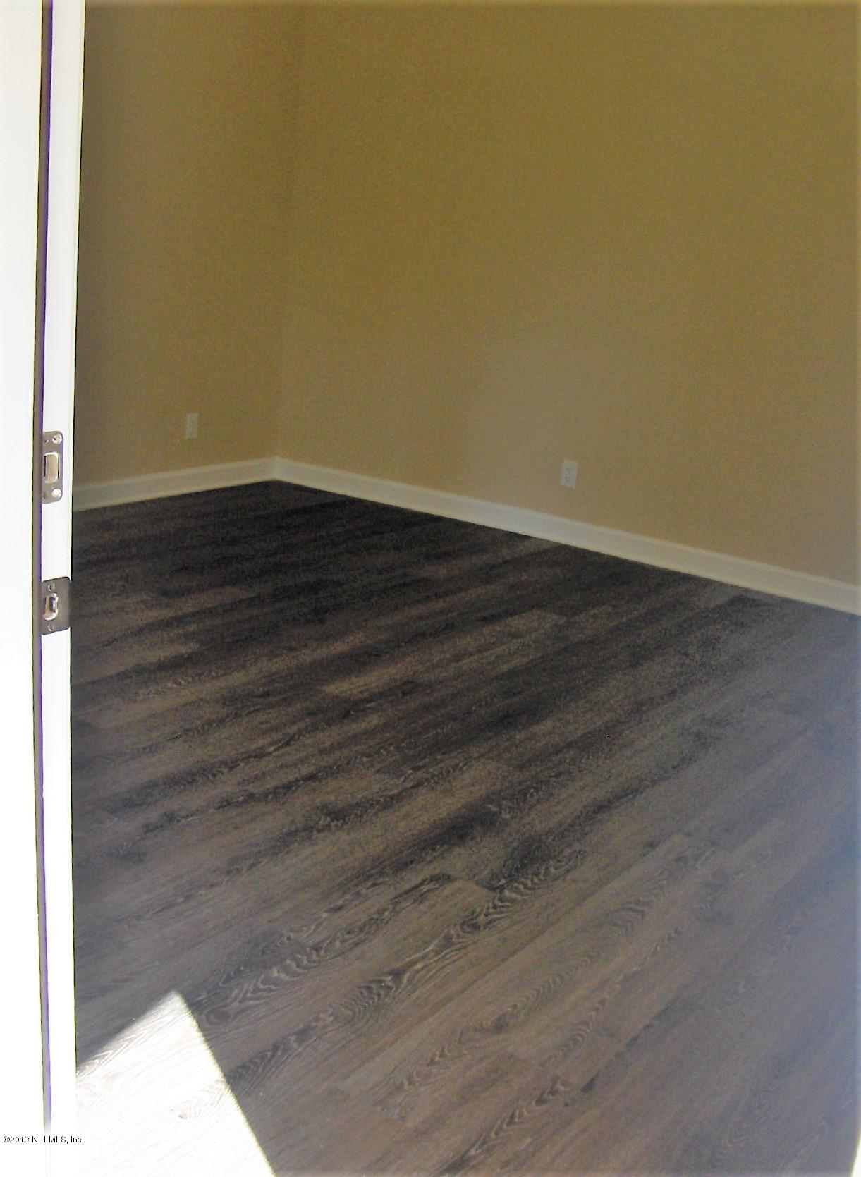 4122 Appaloosa Road Middleburg, FL 32068 - Photo 13 of 18 a view of a room with wooden floor
