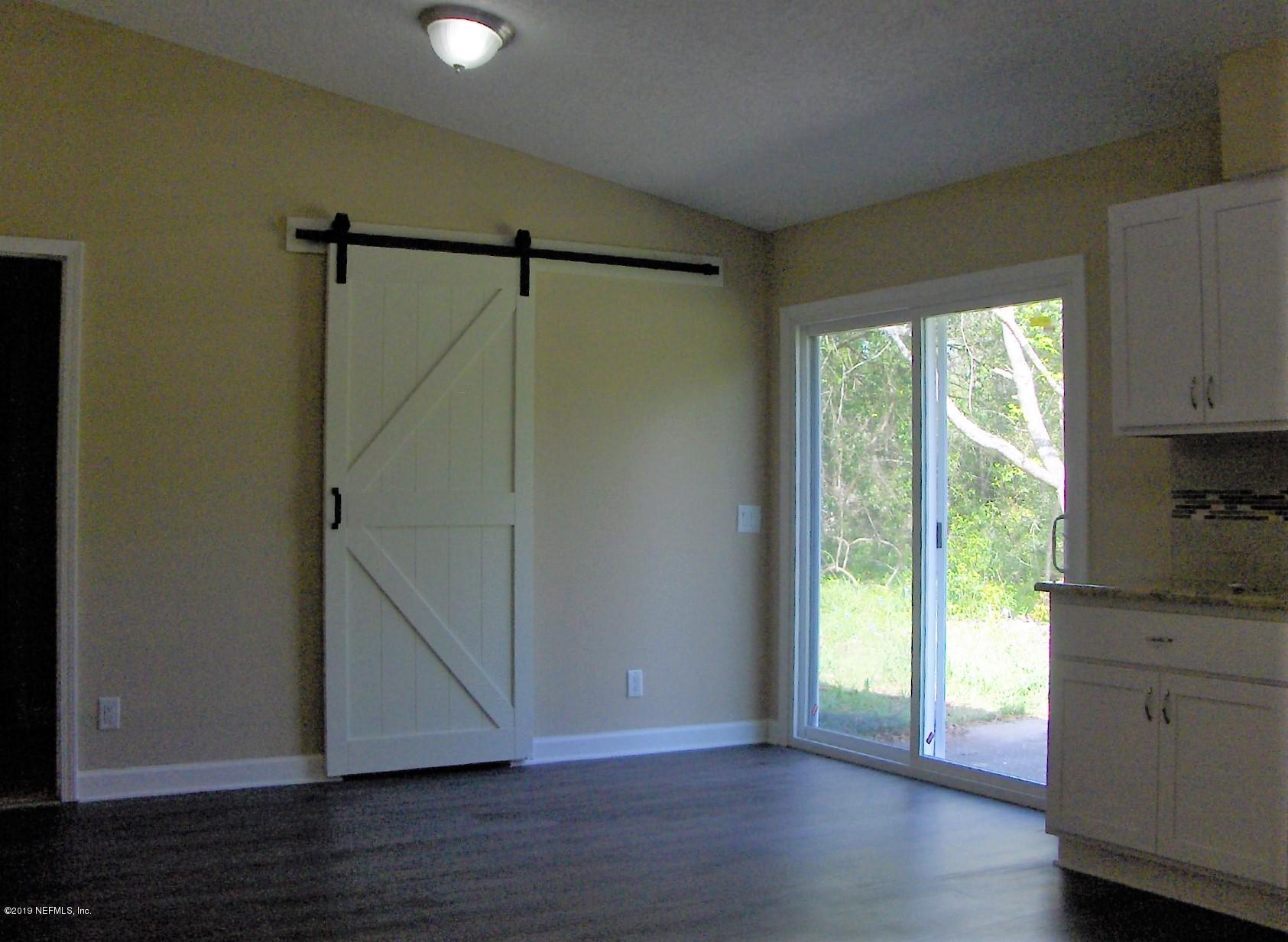4122 Appaloosa Road Middleburg, FL 32068 - Photo 3 of 18 a view of empty room with wooden floor and fan
