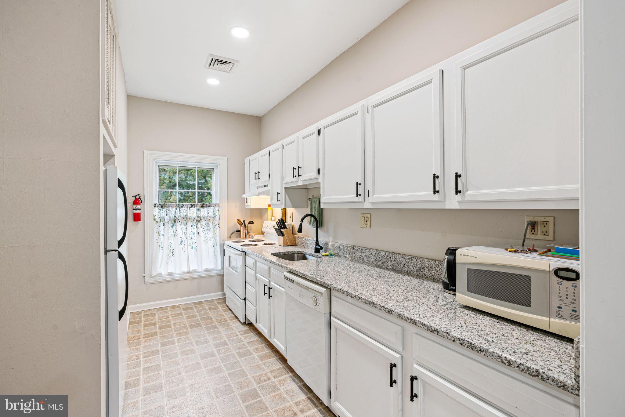 49 B Chestnut Street Haddonfield, NJ 08033 - Photo 1 of 19 a kitchen with white cabinets and sink