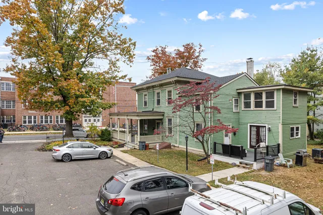 a view of a patio with couches and a table and chairs under an umbrella