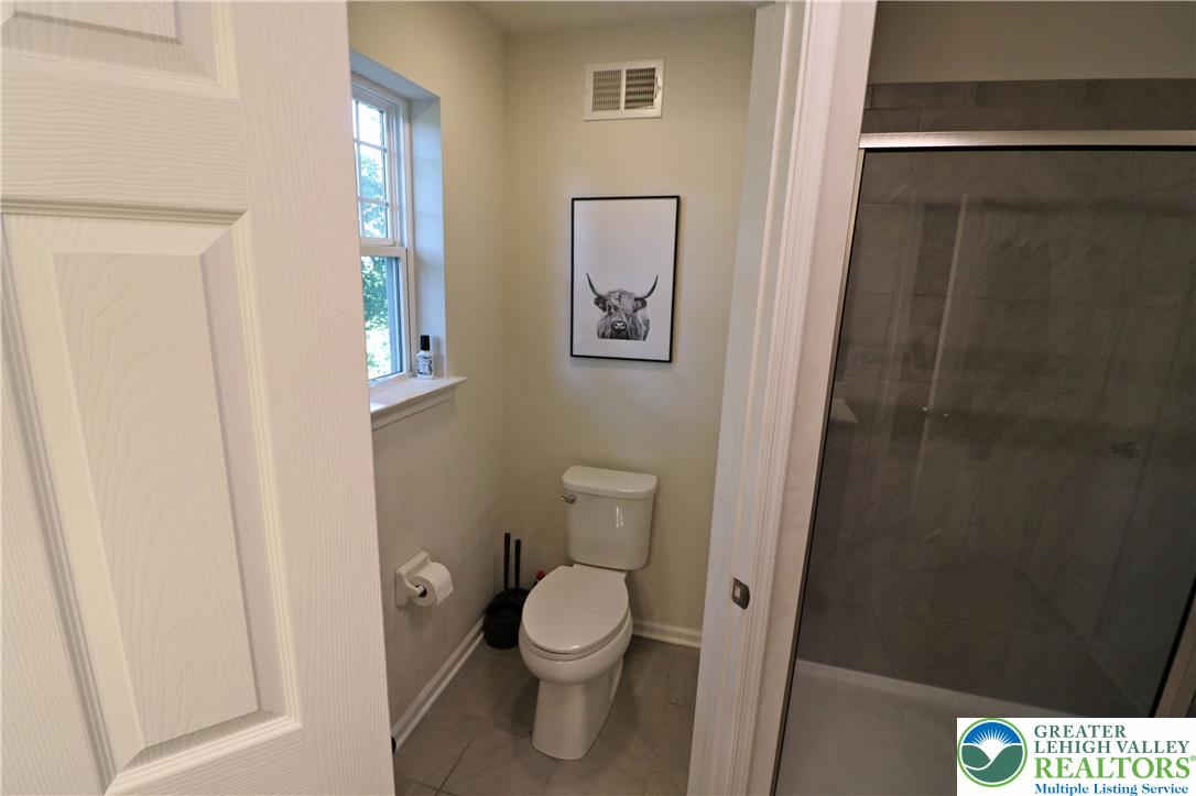 4502 Benjamin Court Emmaus, PA 18049 - Photo 30 of 53 A well-appointed bath with tiled floors and an integrated shower.