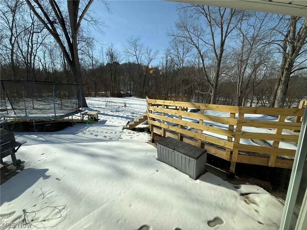 6784 Old Zoarville Road Northeast Dover, OH 44622 - Photo 35 of 50 Snow covered deck featuring a trampoline