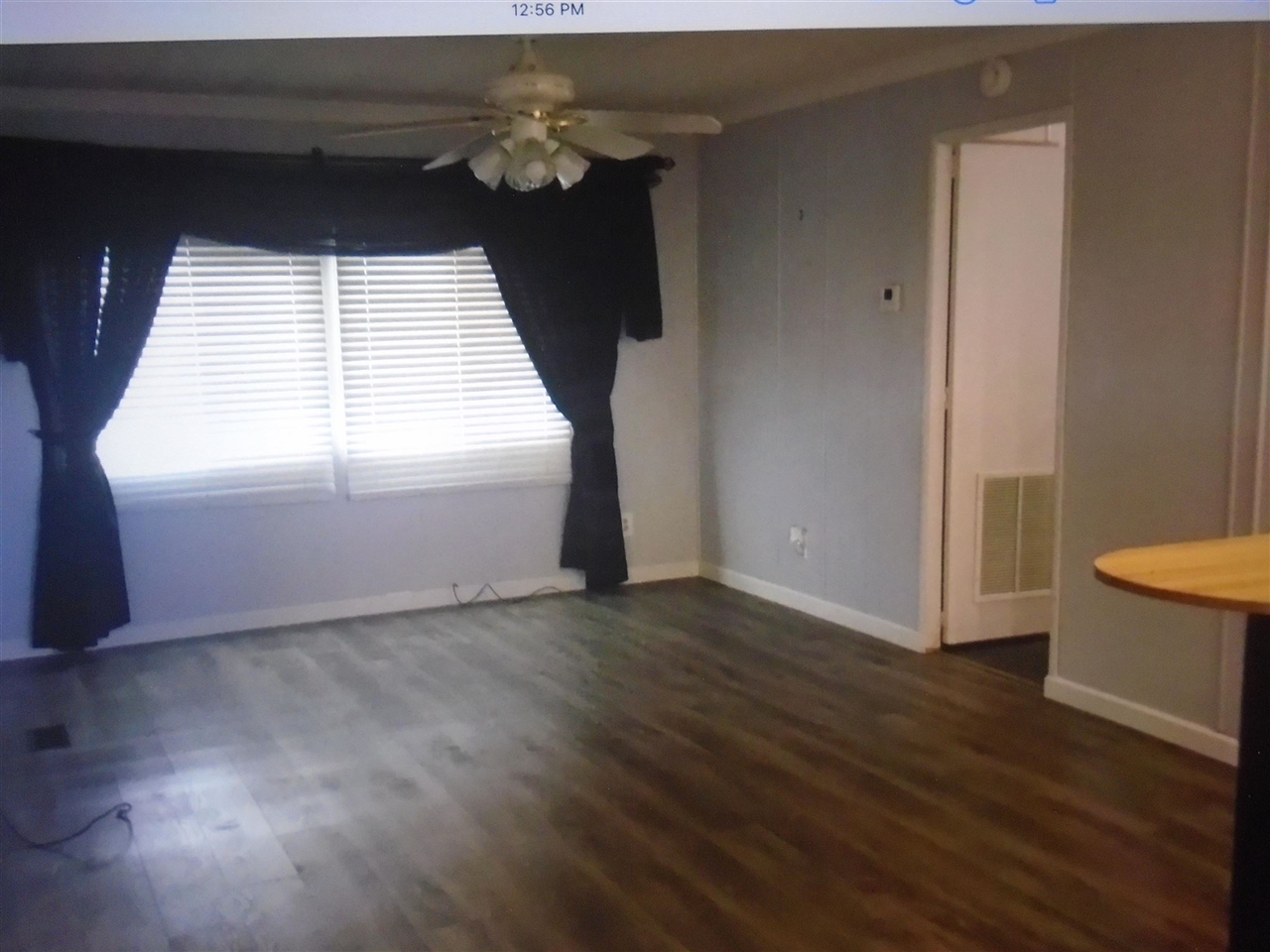 1200 South Carpenter Road, Unit 121 Modesto, CA 95351 - Photo 26 of 35 an empty room with wooden floor and windows