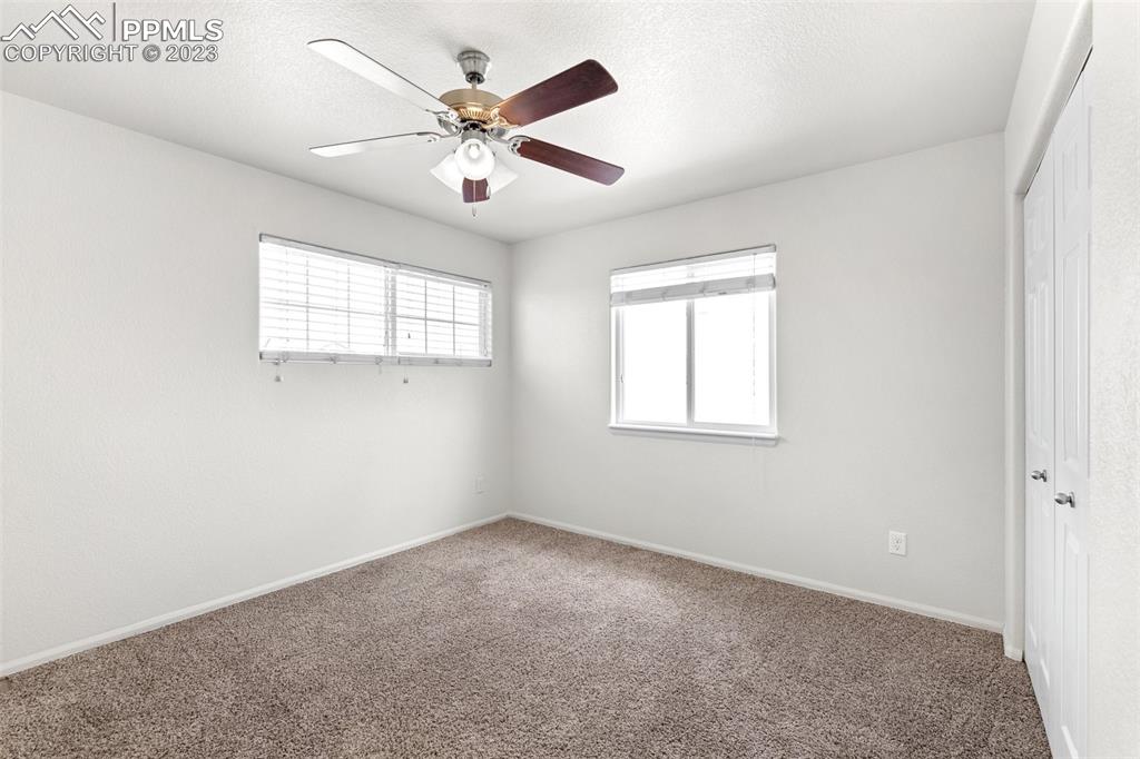 13099 Devil's Thumb Place Peyton, CO 80831 - Photo 19 of 25 an empty room with windows and fan