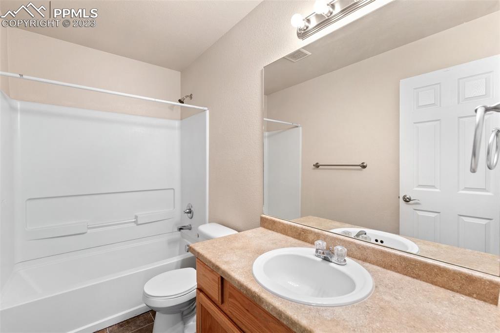 13099 Devil's Thumb Place Peyton, CO 80831 - Photo 20 of 25 a bathroom with a sink toilet and shower