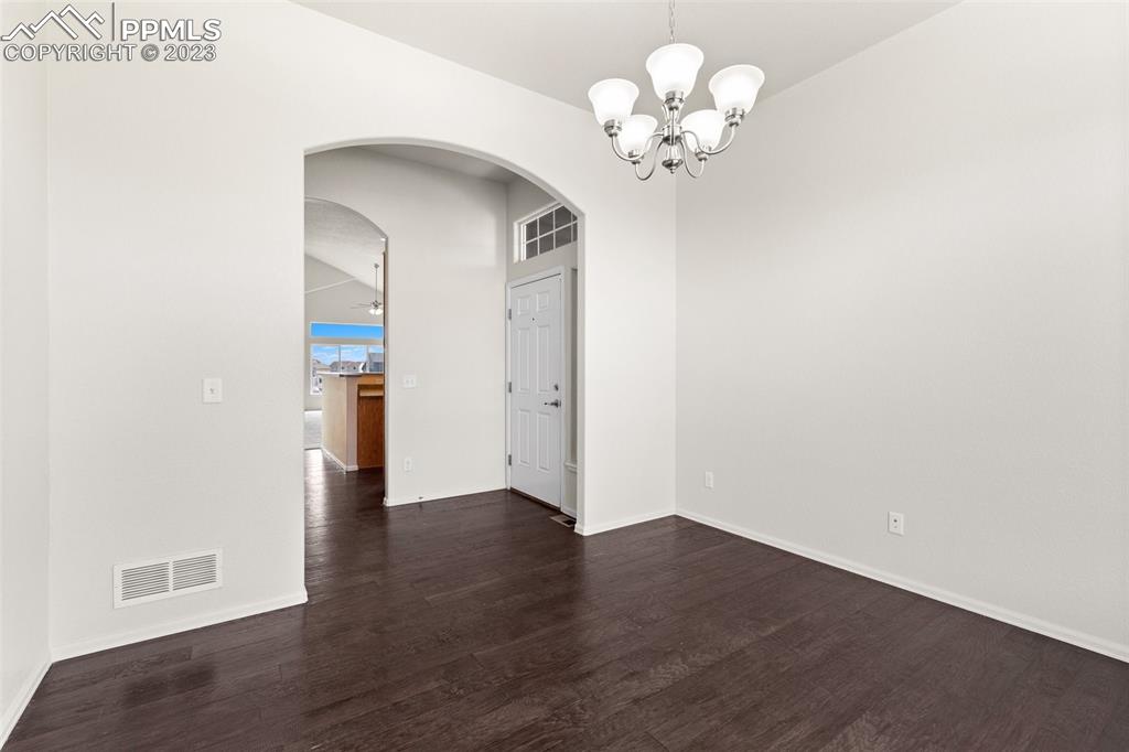 13099 Devil's Thumb Place Peyton, CO 80831 - Photo 5 of 25 a view of an empty room with wooden floor