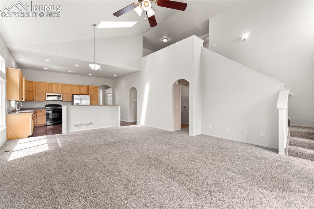 13099 Devil's Thumb Place Peyton, CO 80831 - Photo 8 of 25 a view of a kitchen with refrigerator and a stove