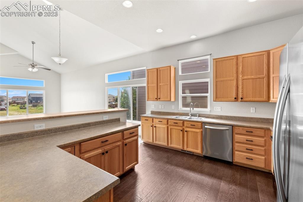 13099 Devil's Thumb Place Peyton, CO 80831 - Photo 9 of 25 a kitchen with stainless steel appliances granite countertop a sink stove and refrigerator