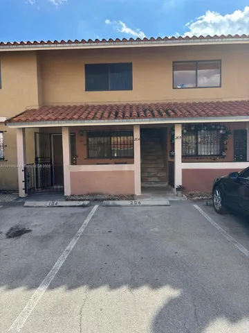 a front view of a house with parking space