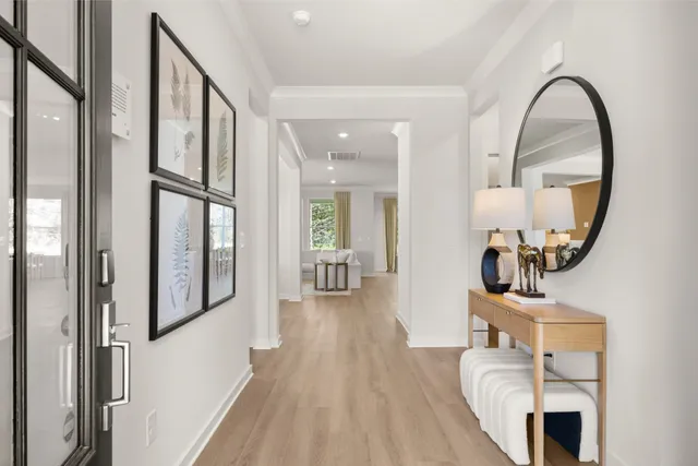 a view of a hallway with wooden floor windows and entryway