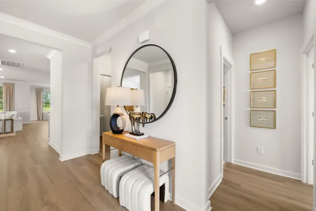 a kitchen with stainless steel appliances granite countertop a stove top oven a sink a dining table and chairs with wooden floor