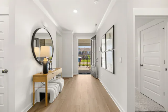 a kitchen with stainless steel appliances kitchen island granite countertop a kitchen island and chairs in it