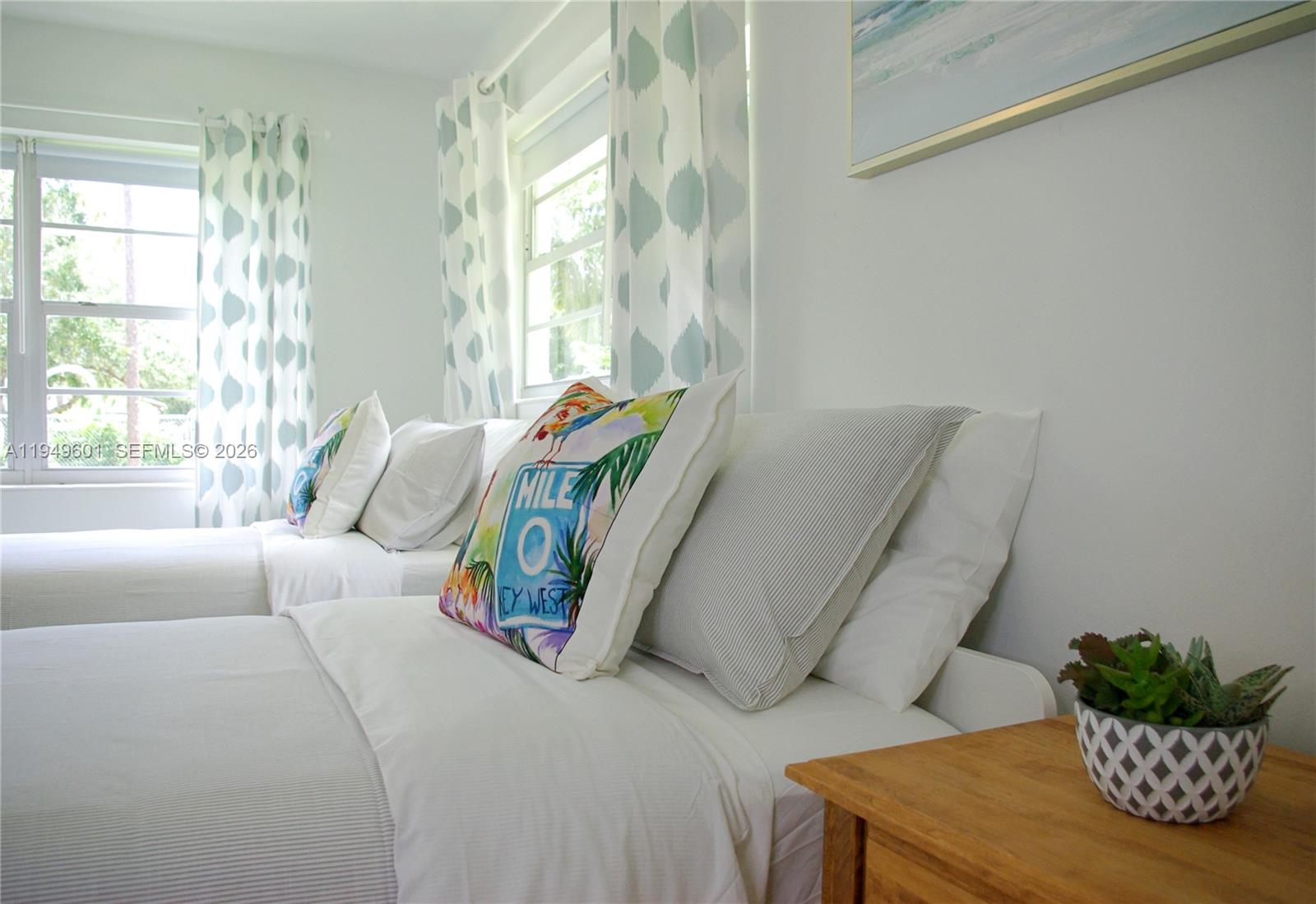 29450 Southwest 180th Avenue Homestead, FL 33030 - Photo 11 of 32 a bedroom with a bed and a potted plant