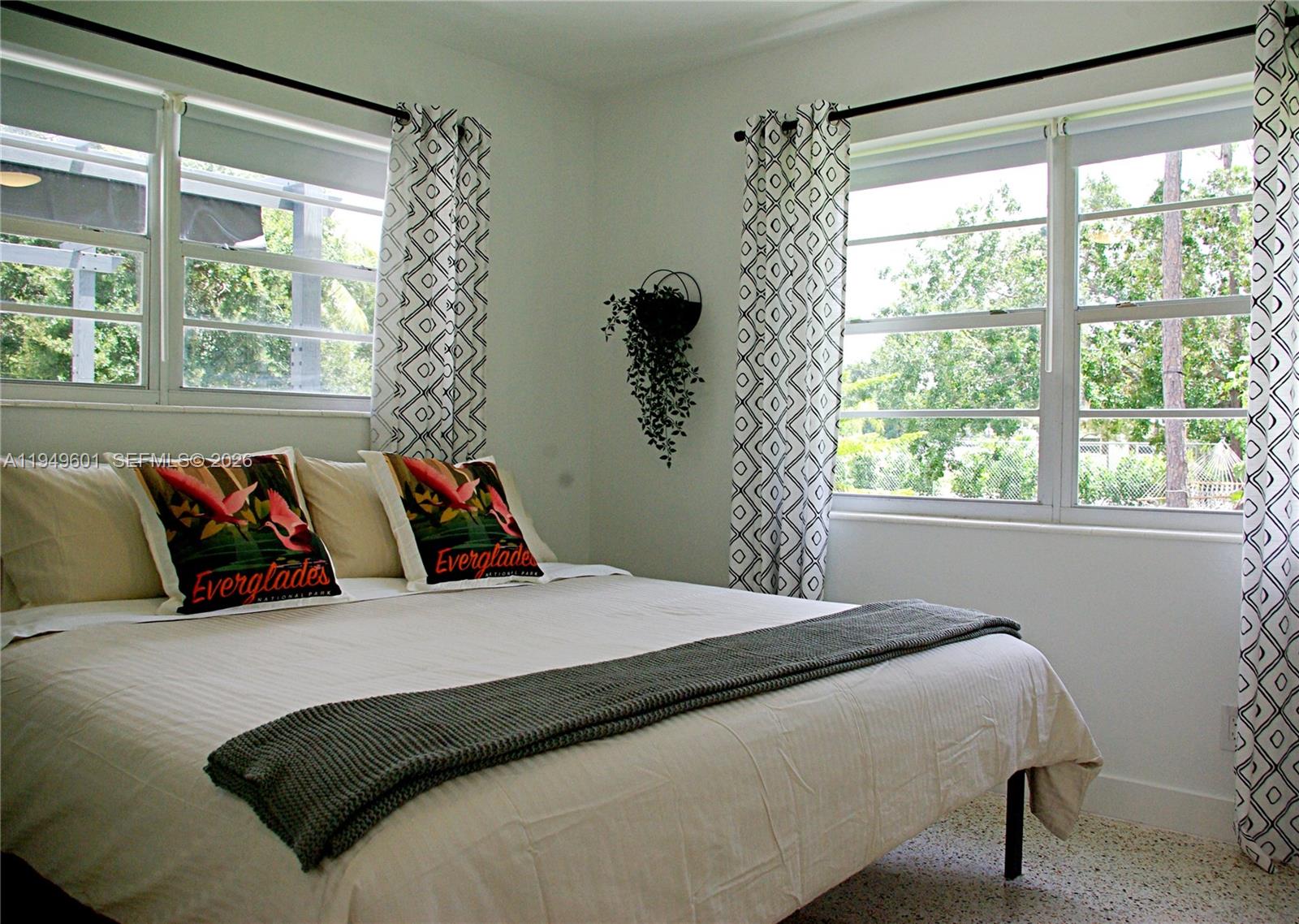 29450 Southwest 180th Avenue Homestead, FL 33030 - Photo 15 of 32 a bedroom with a large bed and a large window