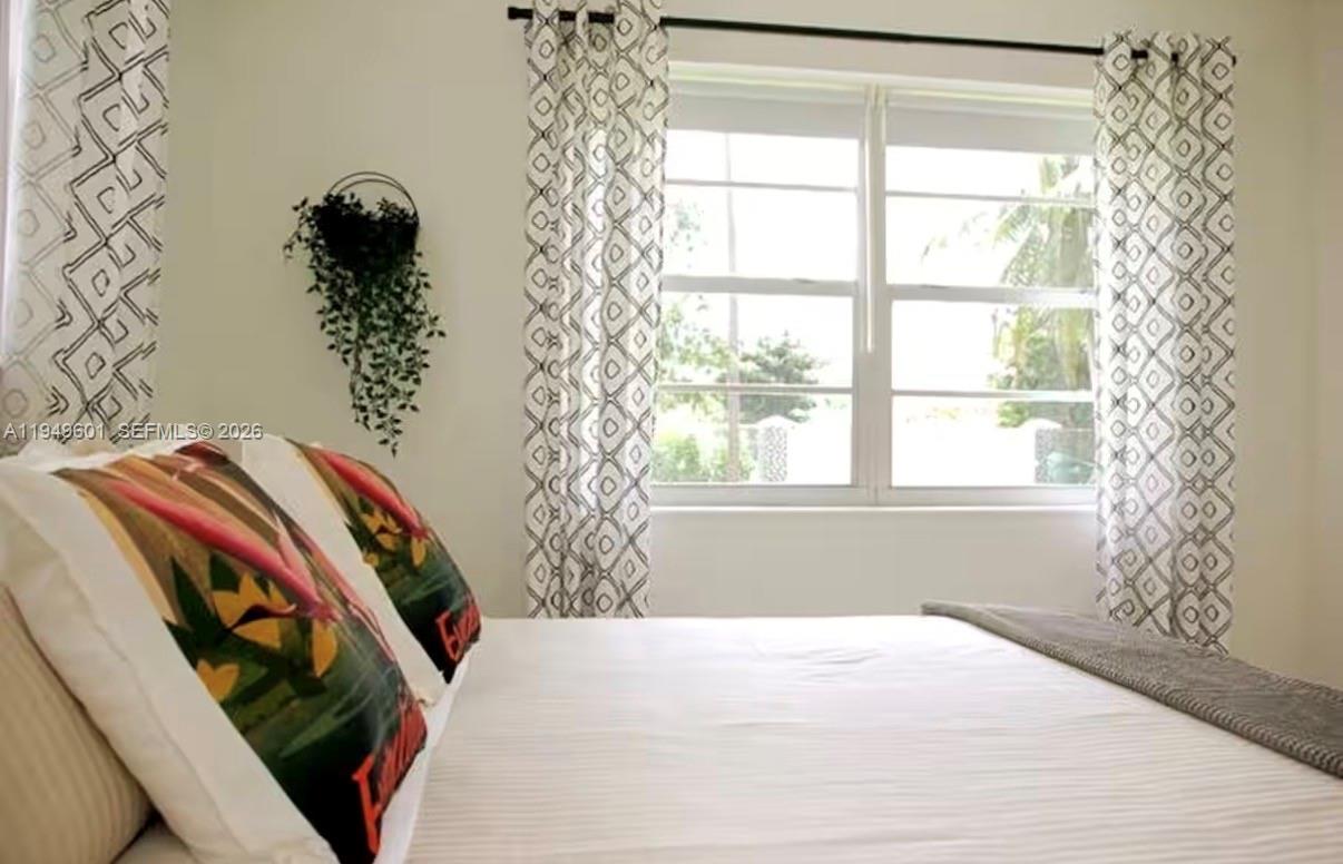 29450 Southwest 180th Avenue Homestead, FL 33030 - Photo 16 of 32 a bedroom with a bed and a window