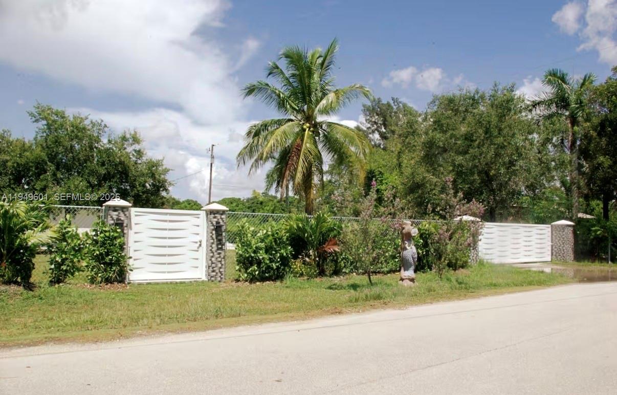 29450 Southwest 180th Avenue Homestead, FL 33030 - Photo 2 of 32 a view of a house with a yard and a garden