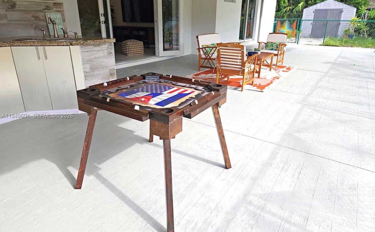 29450 Southwest 180th Avenue Homestead, FL 33030 - Photo 29 of 32 a backyard of a house with table and chairs