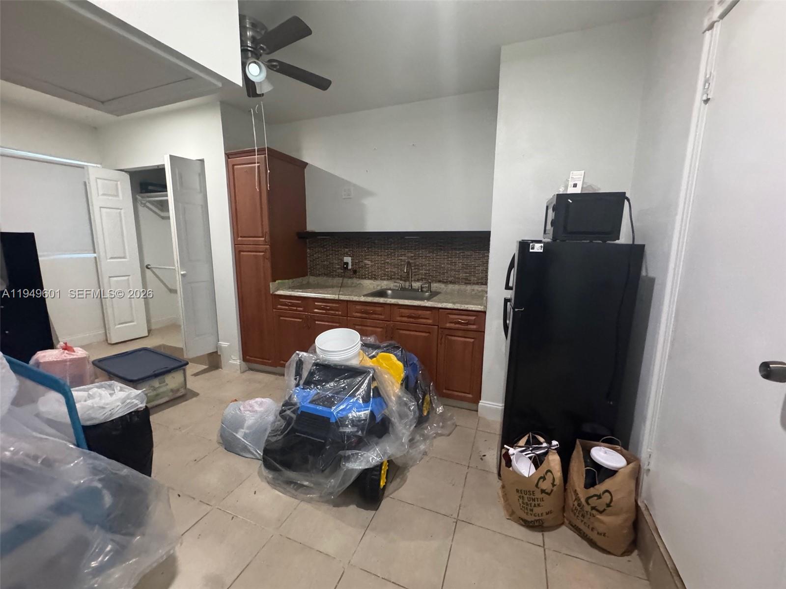 29450 Southwest 180th Avenue Homestead, FL 33030 - Photo 30 of 32 a living room with furniture and flat screen tv