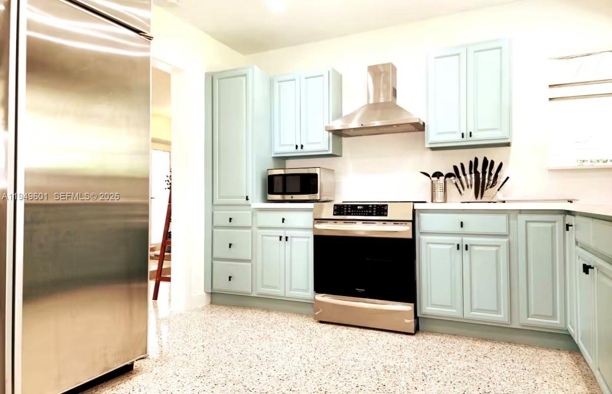 29450 Southwest 180th Avenue Homestead, FL 33030 - Photo 7 of 32 a kitchen with stainless steel appliances a stove a refrigerator and a sink