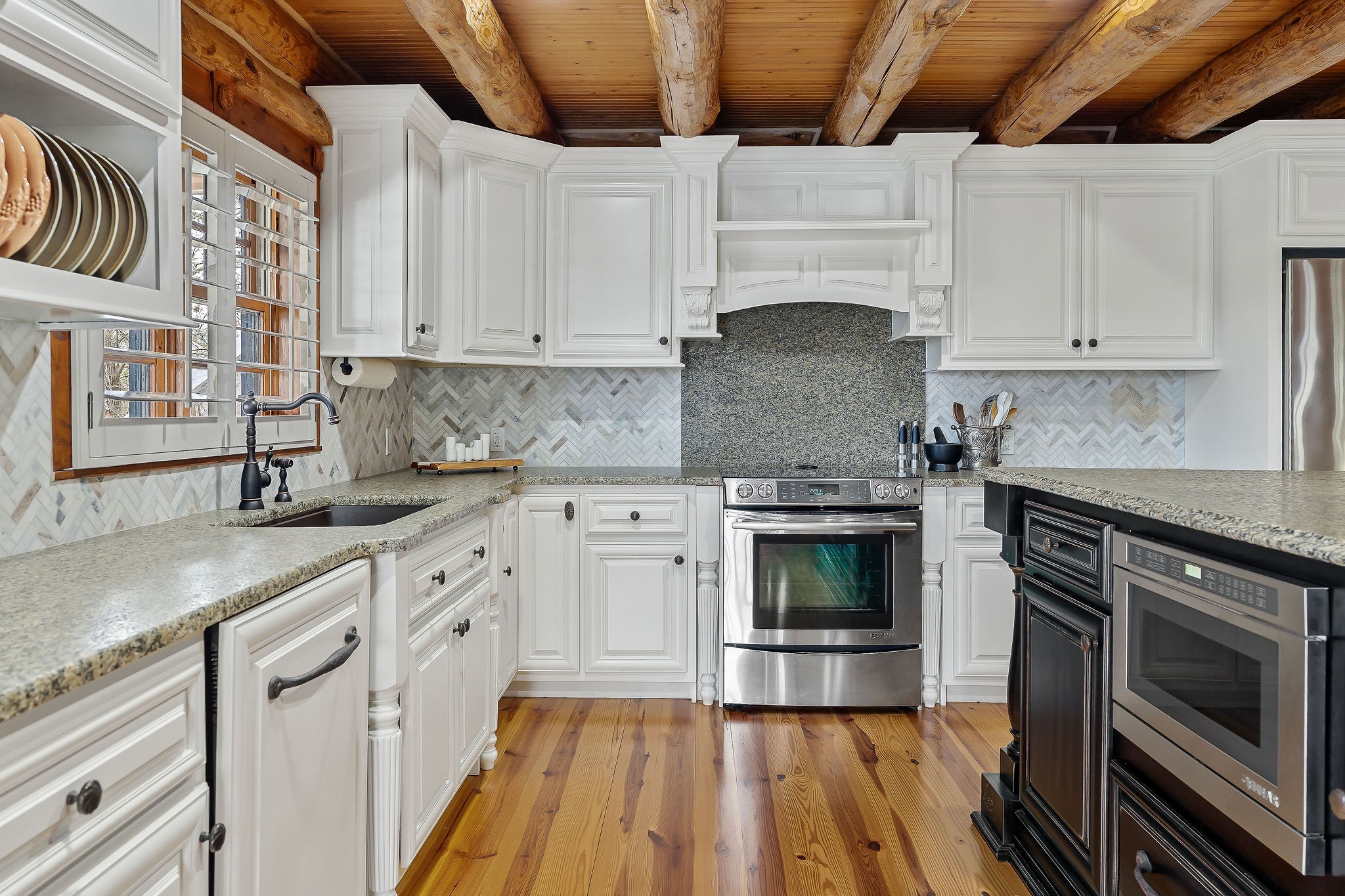 562 Rocky Ridge Road East Rock Island, TN 38581 - Photo 25 of 69 a kitchen with granite countertop a stove top oven a sink dishwasher and cabinets with wooden floor