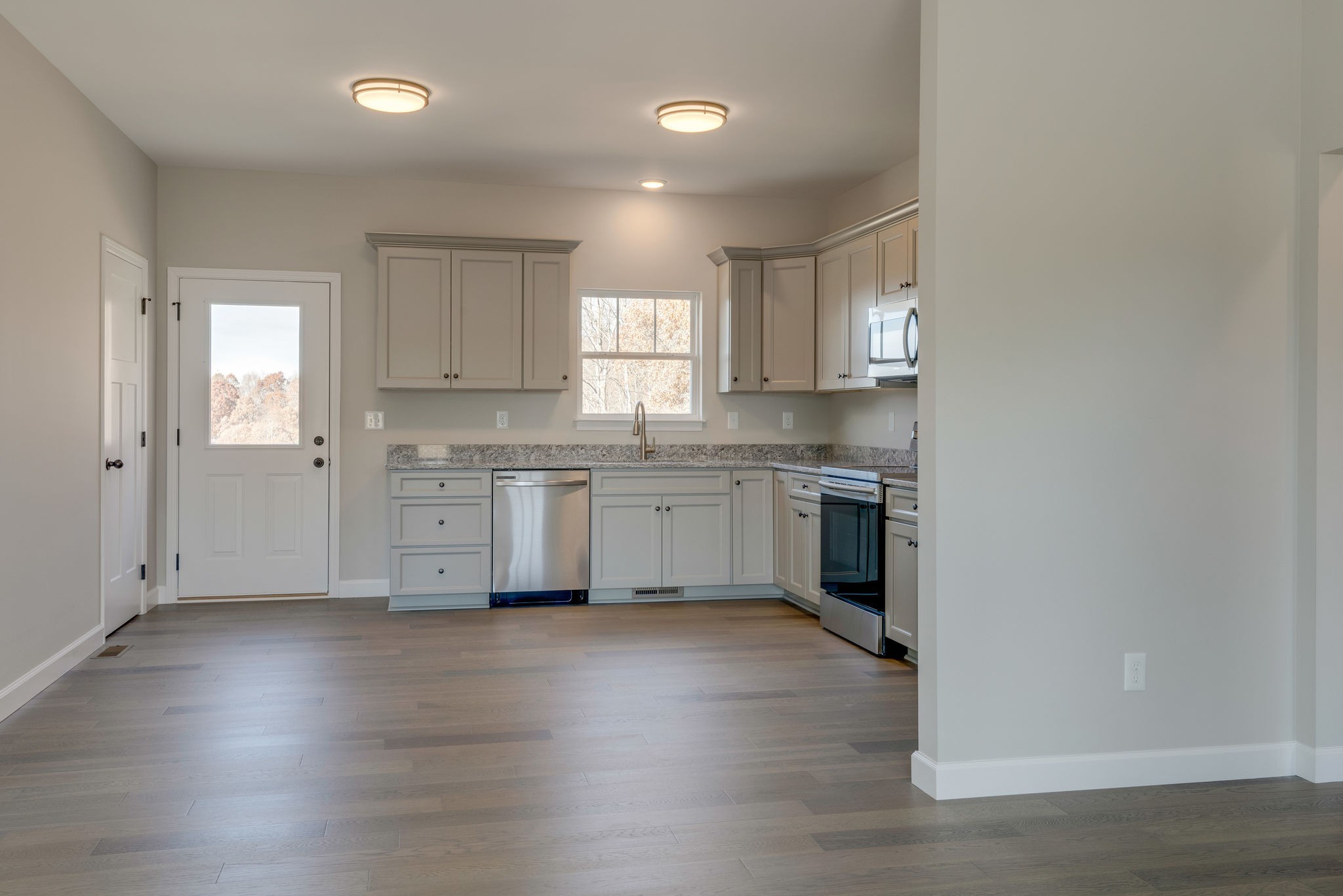 541 Murrell Road Dickson, TN 37055 - Photo 5 of 25 a kitchen with granite countertop a sink cabinets and wooden floor