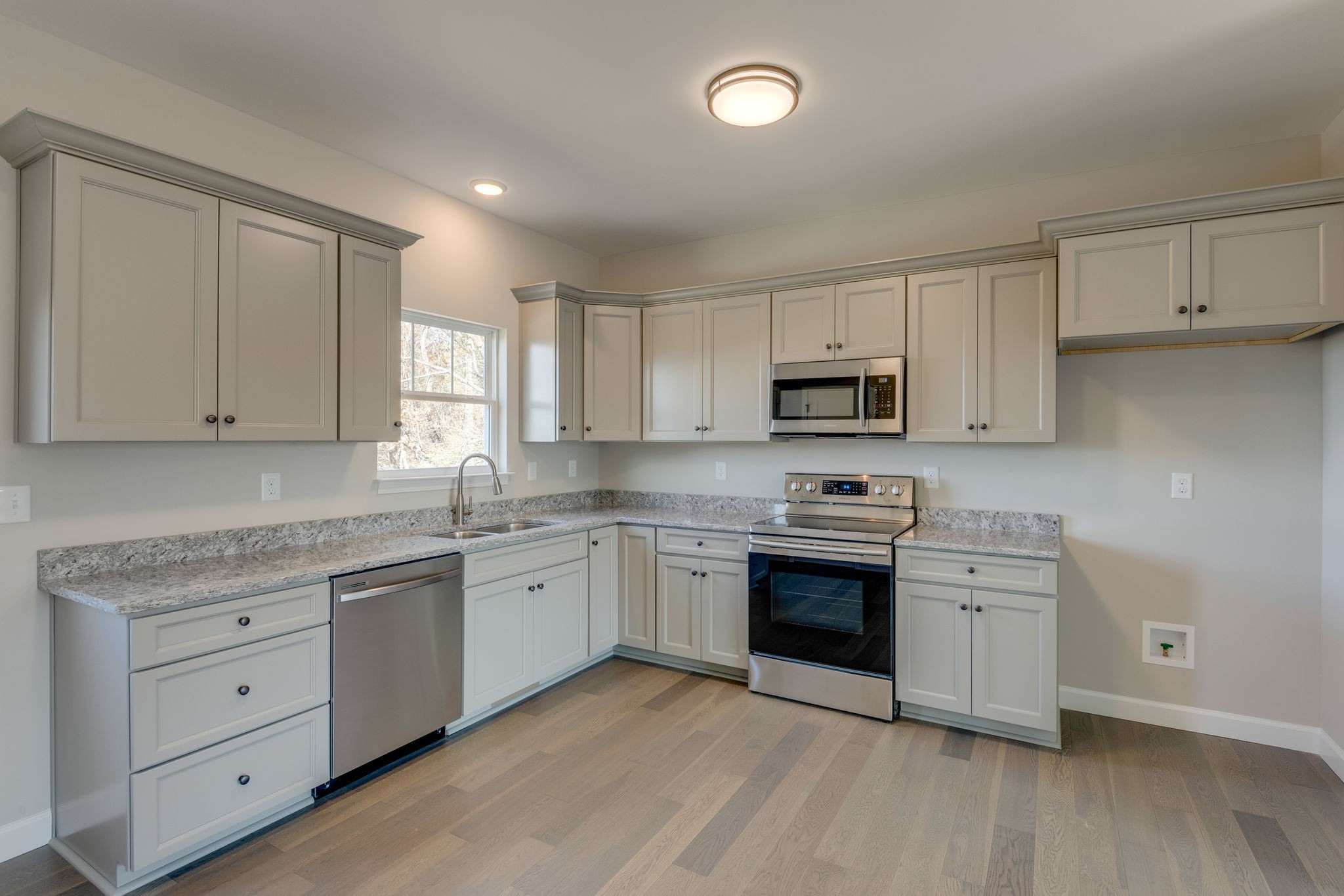 541 Murrell Road Dickson, TN 37055 - Photo 6 of 25 a kitchen with granite countertop white cabinets and stainless steel appliances