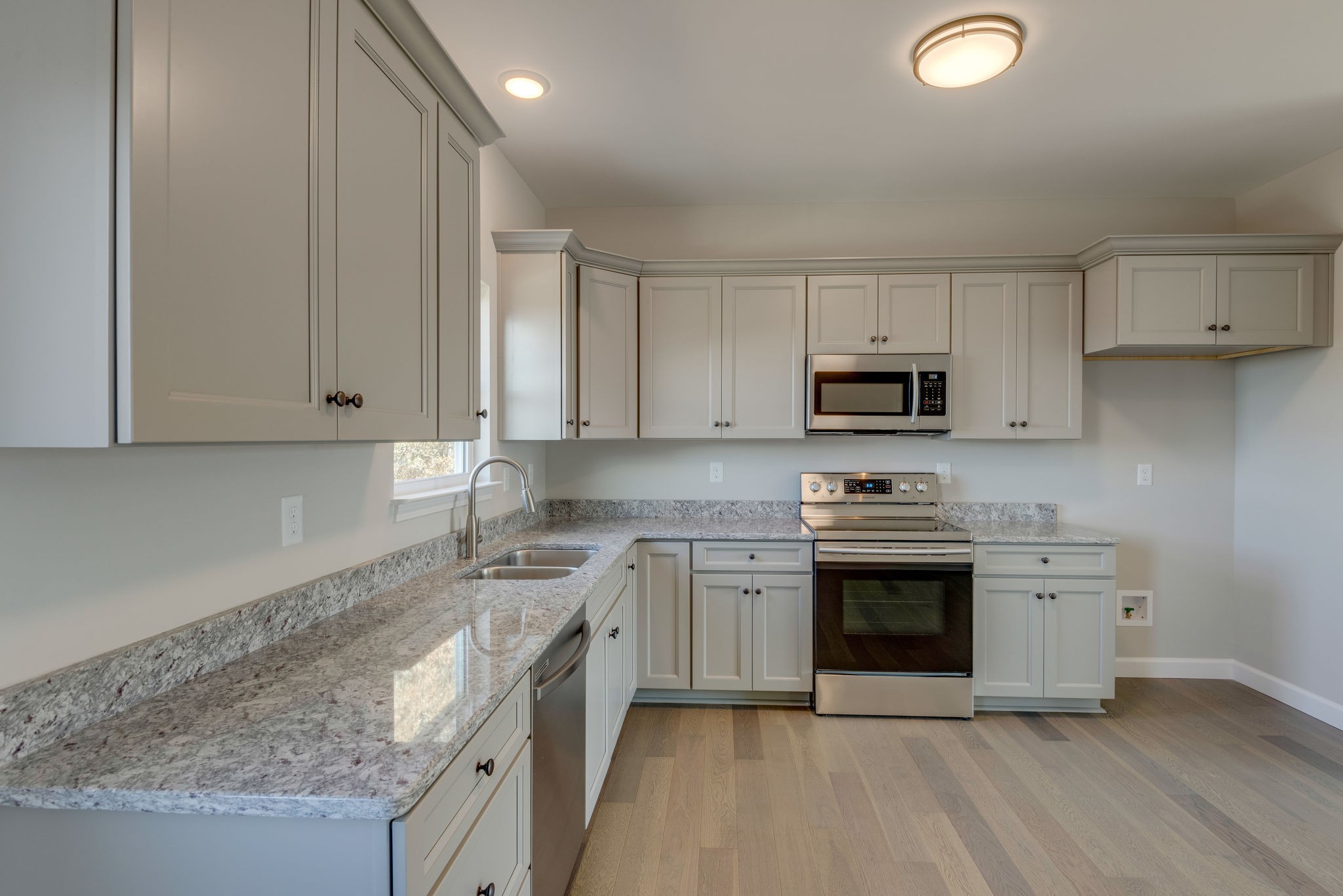 541 Murrell Road Dickson, TN 37055 - Photo 7 of 25 a kitchen with stainless steel appliances granite countertop a stove a sink and a microwave