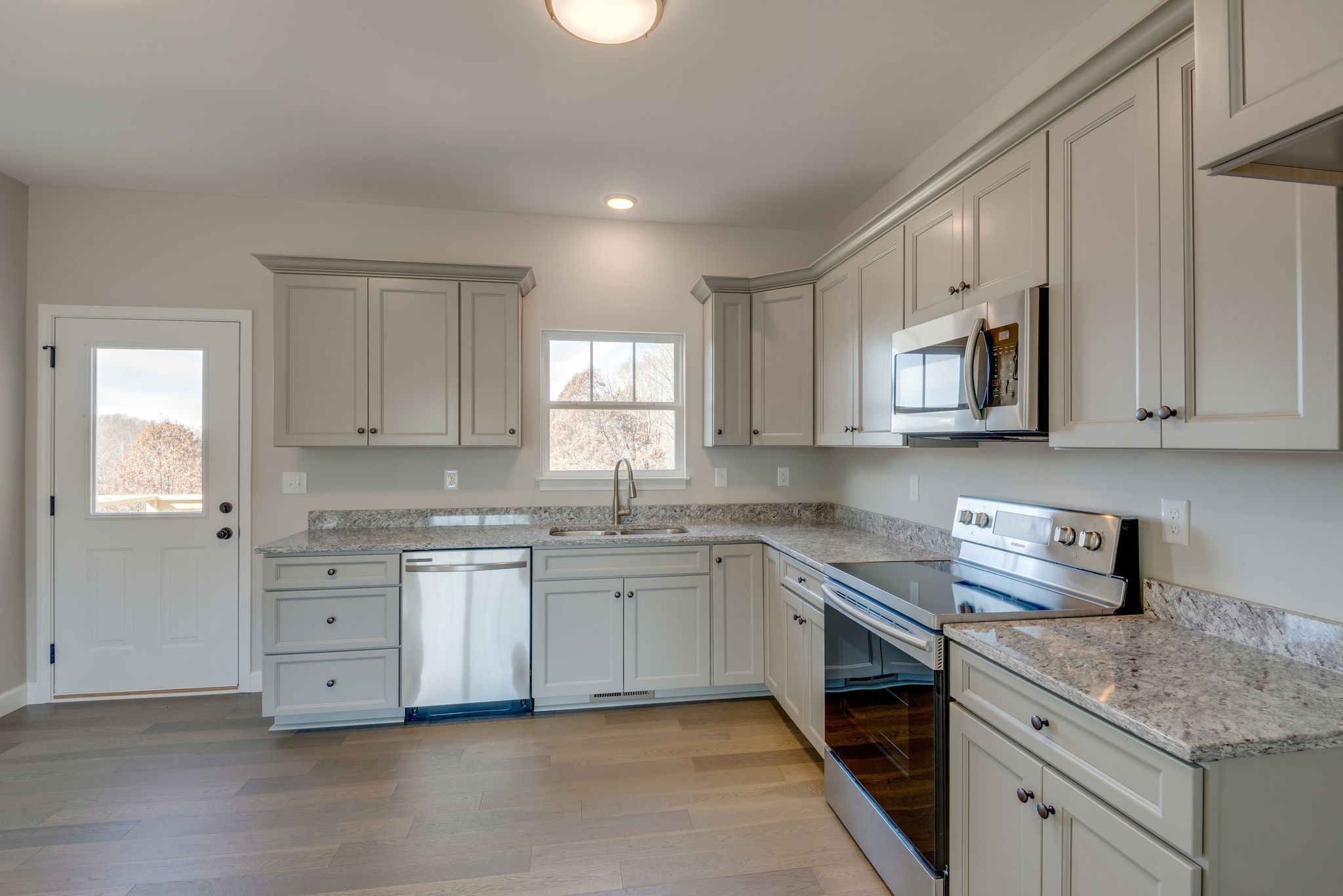 541 Murrell Road Dickson, TN 37055 - Photo 8 of 25 a kitchen with granite countertop white cabinets white stainless steel appliances with a sink and dishwasher