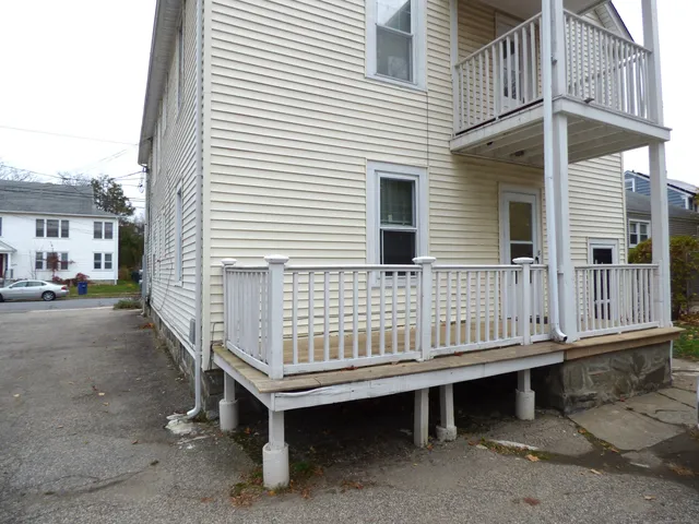 a view of a house with a yard and sitting area