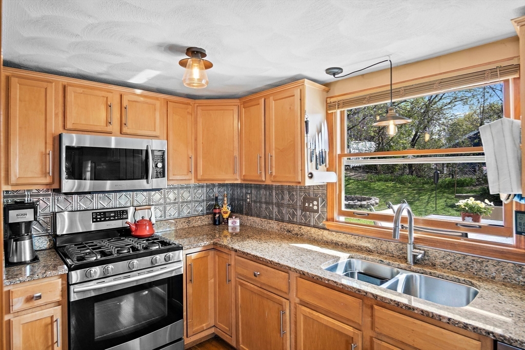 4 Jeffrey Road Billerica, MA 01821 - Photo 15 of 34 a kitchen with stainless steel appliances granite countertop a sink stove and cabinets