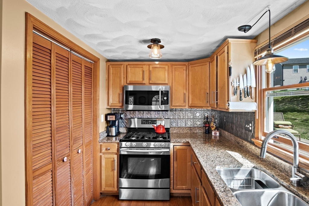 4 Jeffrey Road Billerica, MA 01821 - Photo 16 of 34 a kitchen with stainless steel appliances granite countertop a sink stove and cabinets