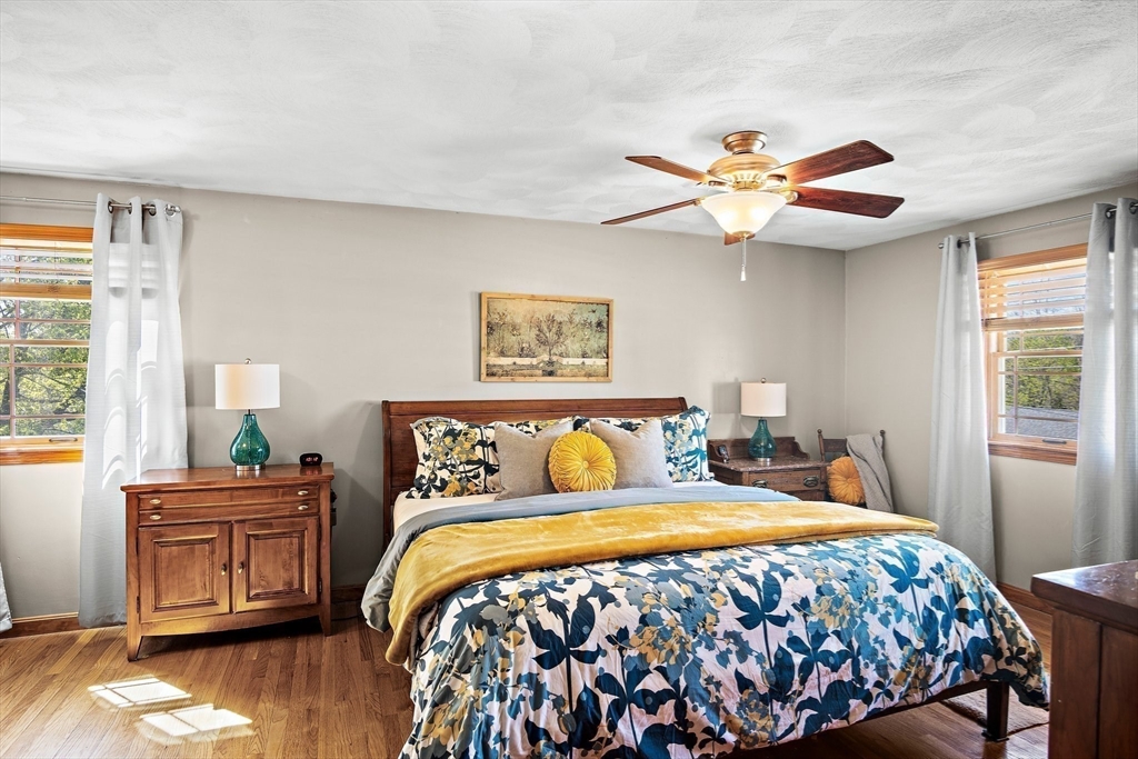 4 Jeffrey Road Billerica, MA 01821 - Photo 20 of 34 a bedroom with a bed and a chandelier