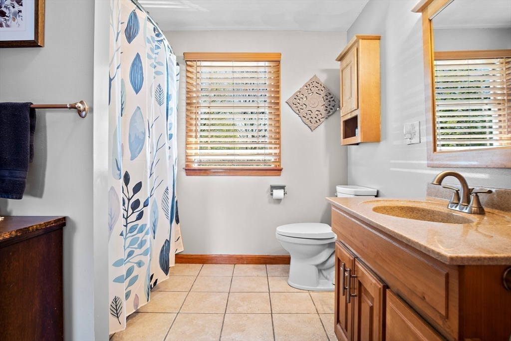 4 Jeffrey Road Billerica, MA 01821 - Photo 27 of 34 a bathroom with a sink a toilet and a shower curtain