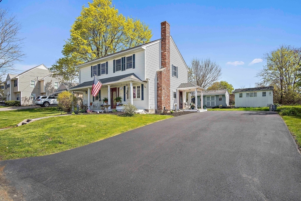 4 Jeffrey Road Billerica, MA 01821 - Photo 6 of 34 a front view of a house with a garden and plants