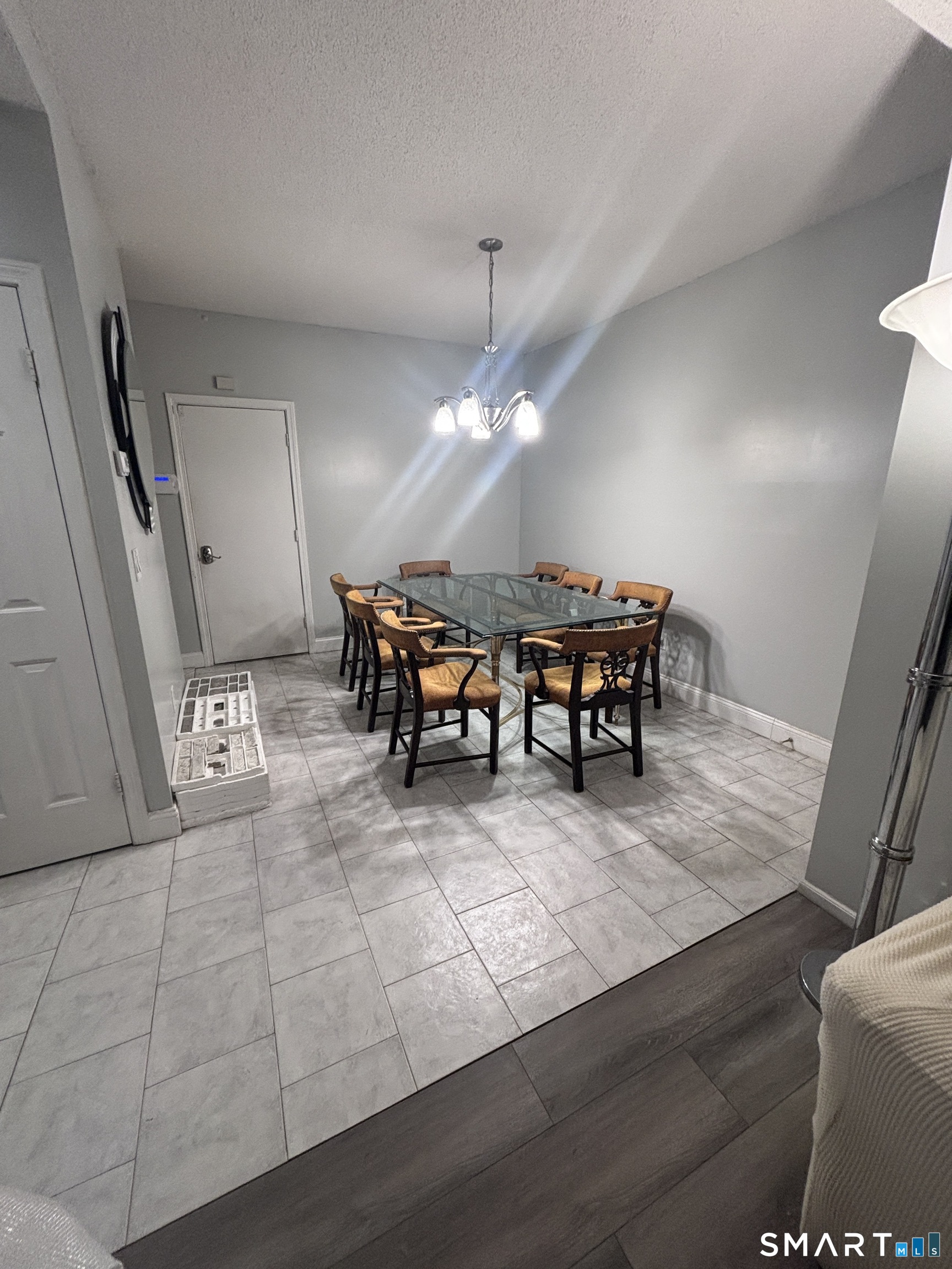 101 Madeline Avenue, Unit 33 Waterbury, CT 06708 - Photo 14 of 41 a living room with furniture and a chandelier