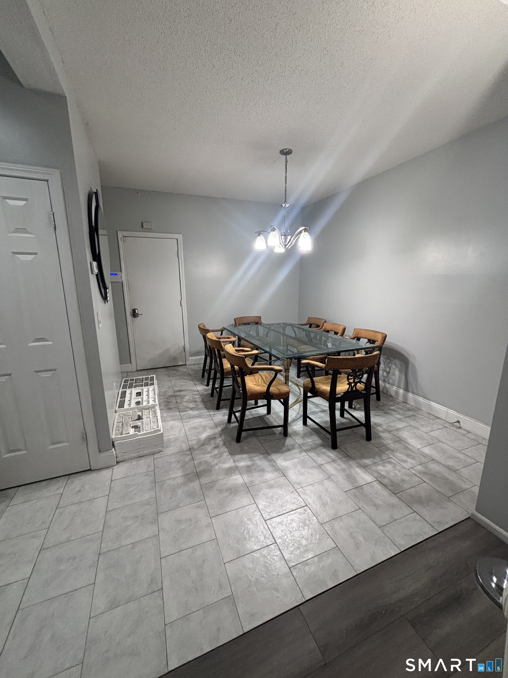 101 Madeline Avenue, Unit 33 Waterbury, CT 06708 - Photo 15 of 41 a view of a room with furniture and a chandelier