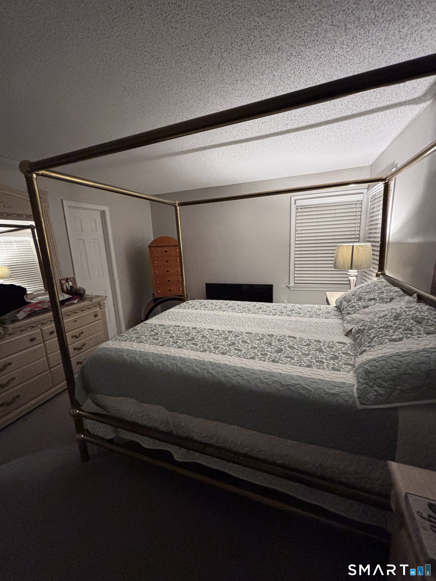 101 Madeline Avenue, Unit 33 Waterbury, CT 06708 - Photo 23 of 41 a bedroom with a bed and wooden floor